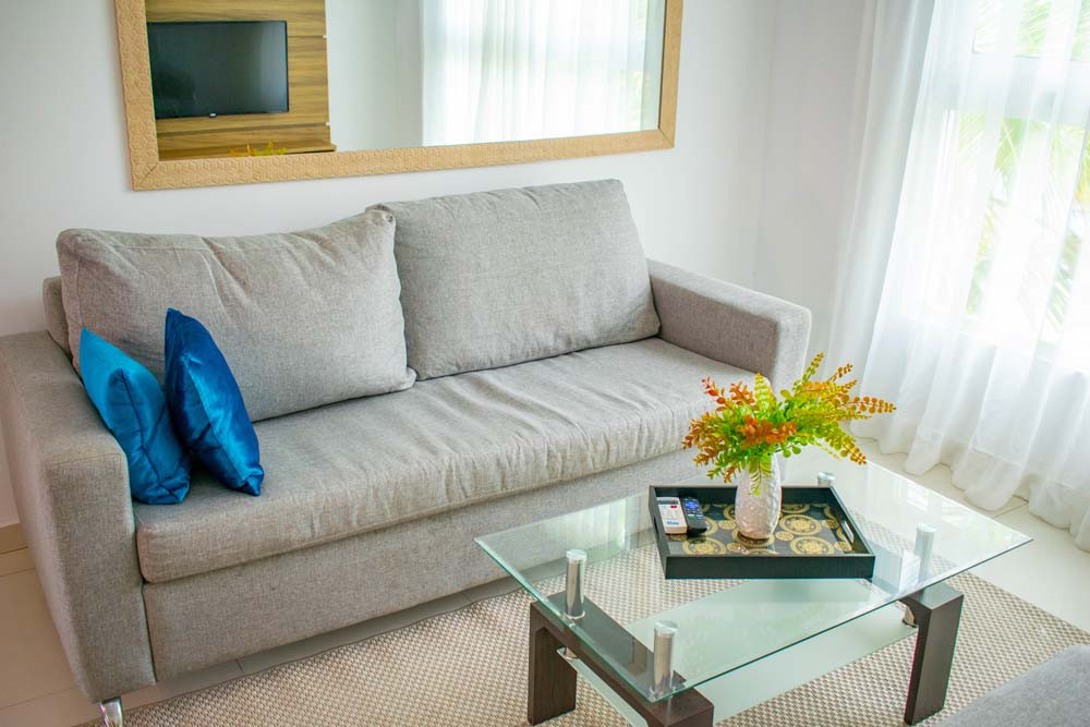 Sofa with cushions and coffee table at Beach Apartamentos in Playa Palmera
